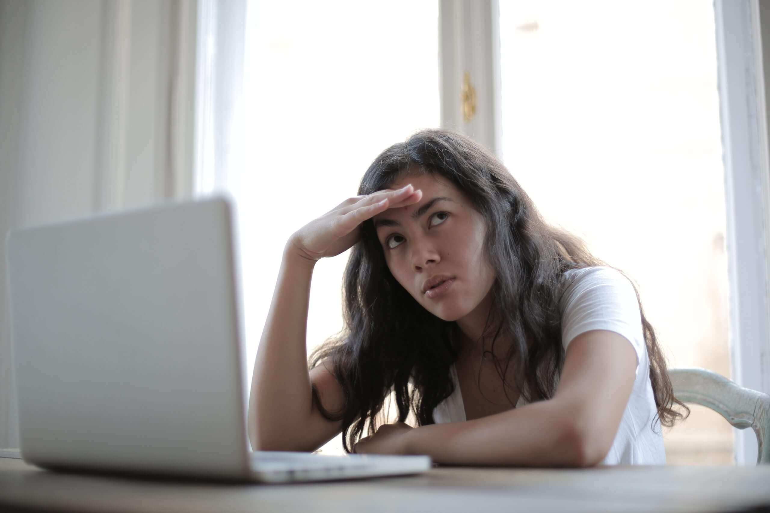 How to Remove Distractions When Working from Home young-annoyed-female-freelancer-using-laptop-at-home-3808008